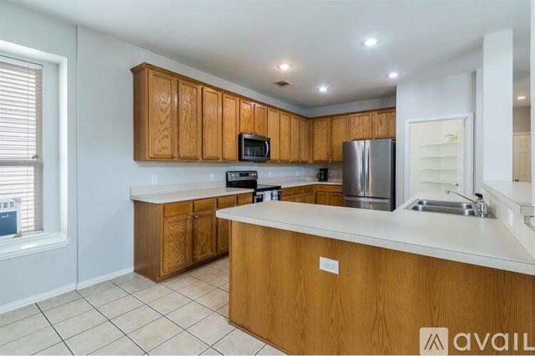 A kitchen with wooden cabinets and a white countertop.