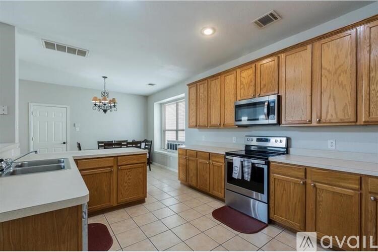 A kitchen with wooden cabinets and a white countertop.