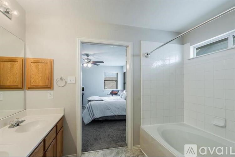 A bathroom with a bedroom visible through the open door.