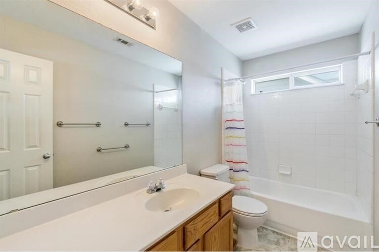A bathroom with a white sink and toilet.
