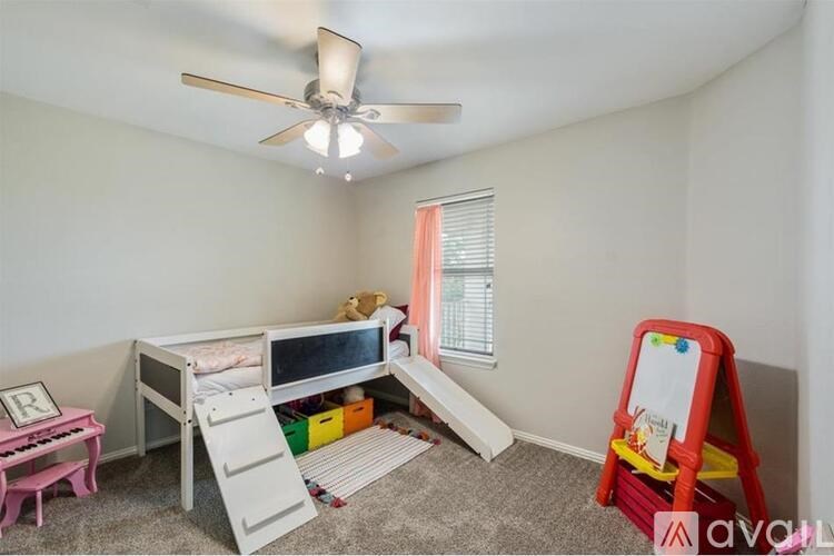 A child's bedroom with a bunk bed, a toy chest, and a play mat.