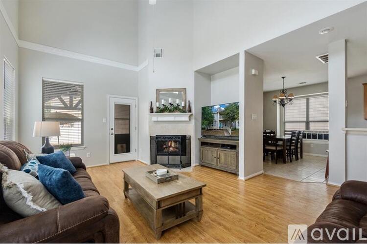 A living room with a brown couch and a coffee table.