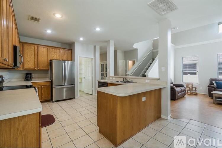 A kitchen with wooden cabinets and a white countertop.