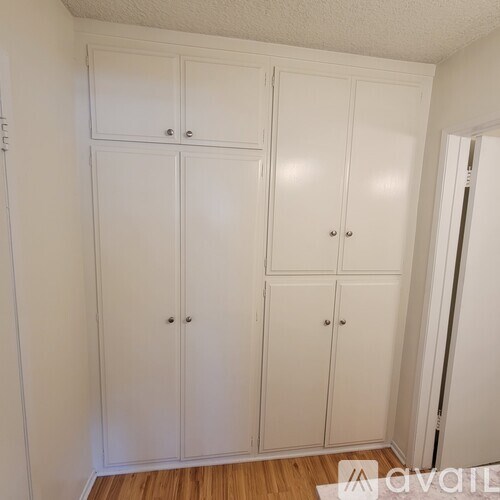 A set of four white doors are closed.