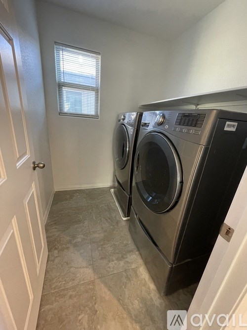 A laundry room with a washer and dryer.