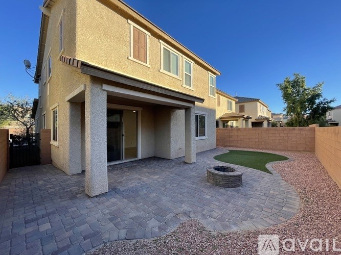 A modern house with a patio and a small garden.