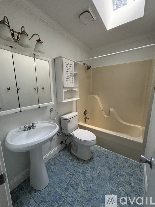 A bathroom with a sink, toilet and bathtub.