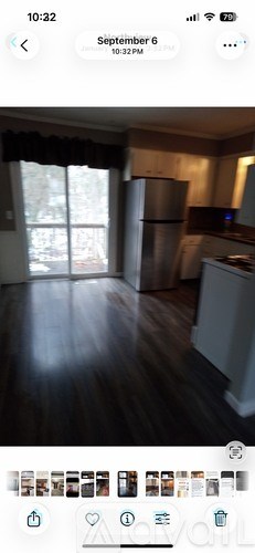 A kitchen with a refrigerator and a stove top oven.