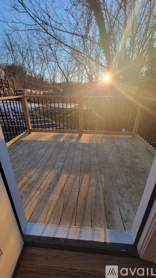 A deck with wooden planks and a railing is shown in the image.