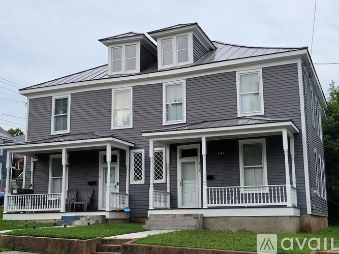 A two-story house with a porch and a balcony.