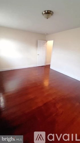 A room with a wooden floor and a door.