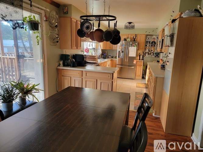 A kitchen with wooden cabinets and a table.