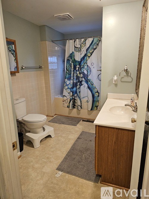 A bathroom with a toilet, sink, and shower.