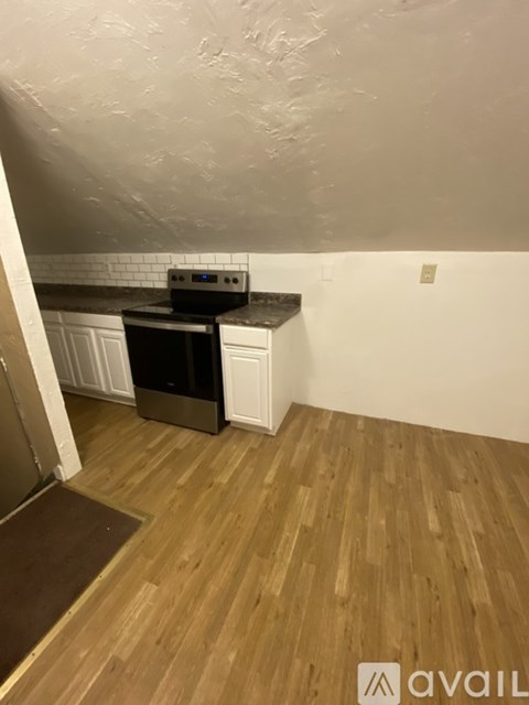 A kitchen with a stove top oven and a microwave.