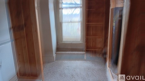 A room with wooden walls and a carpeted floor.