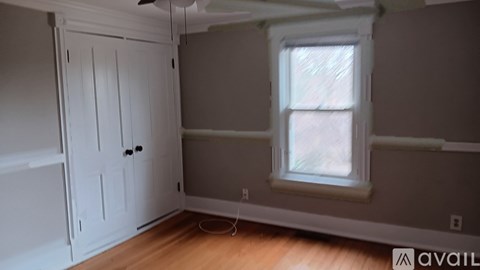 A room with a white door and a window.