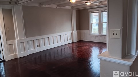 A room with wooden floors and white walls.