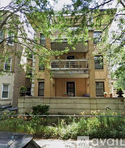 A building with a balcony and a fence in front of it.