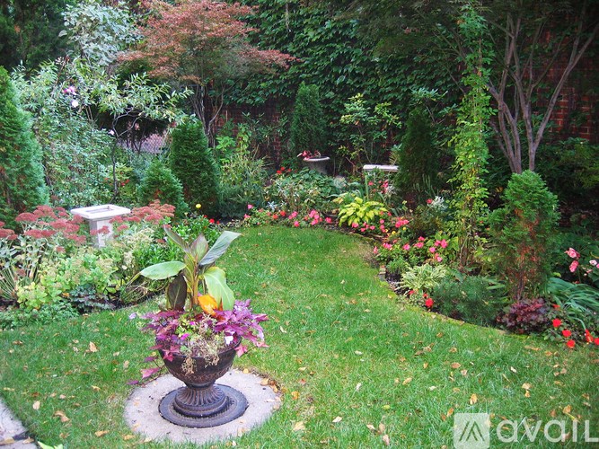 A garden with a large flower pot in the middle.