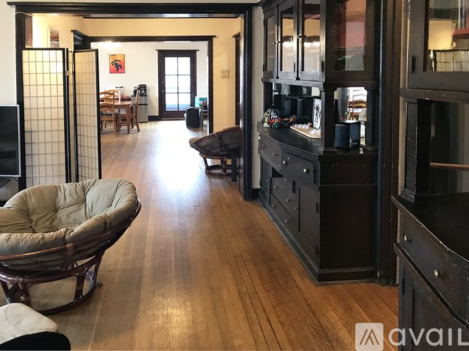 A living room with a chair and a cabinet.