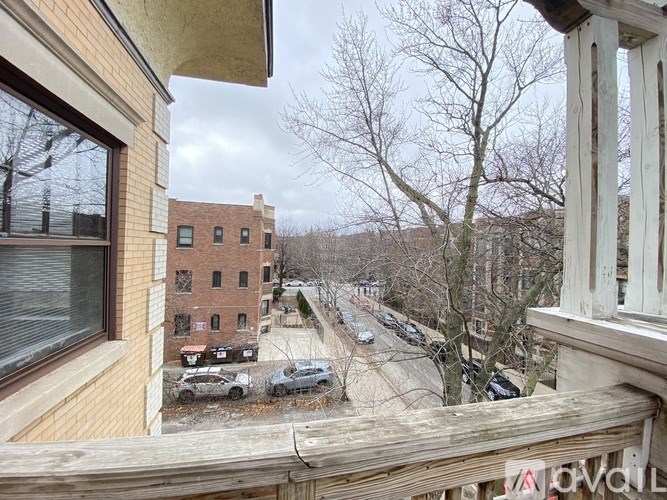 A view from a balcony looking down a quiet street.