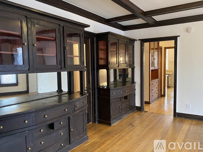 A room with dark wood cabinets and drawers.