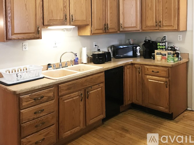 A kitchen with wooden cabinets and a sink.
