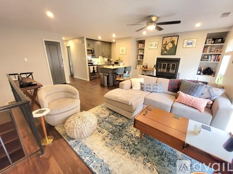 A living room with a white couch and a rug.
