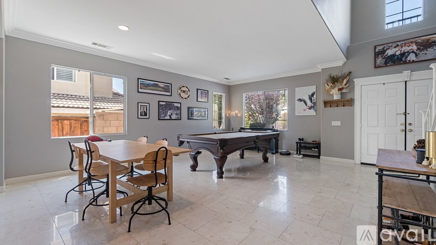 A dining room with a table and chairs.