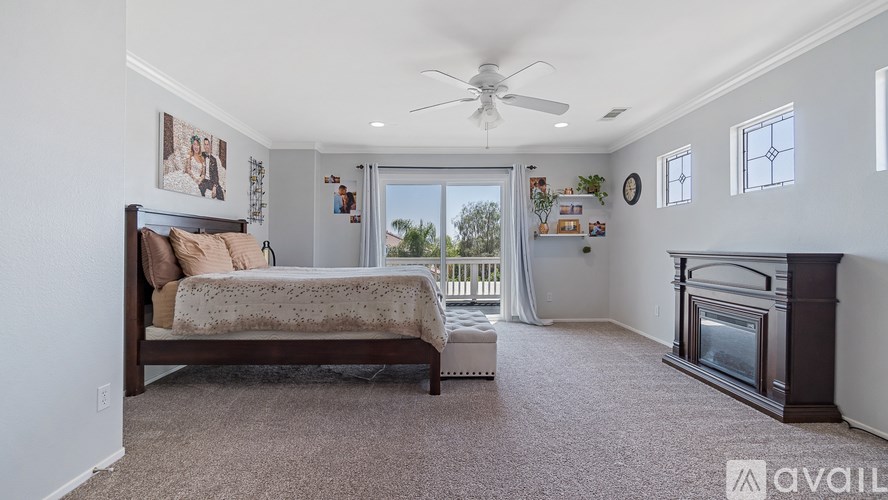 A bedroom with a large bed and a fireplace.