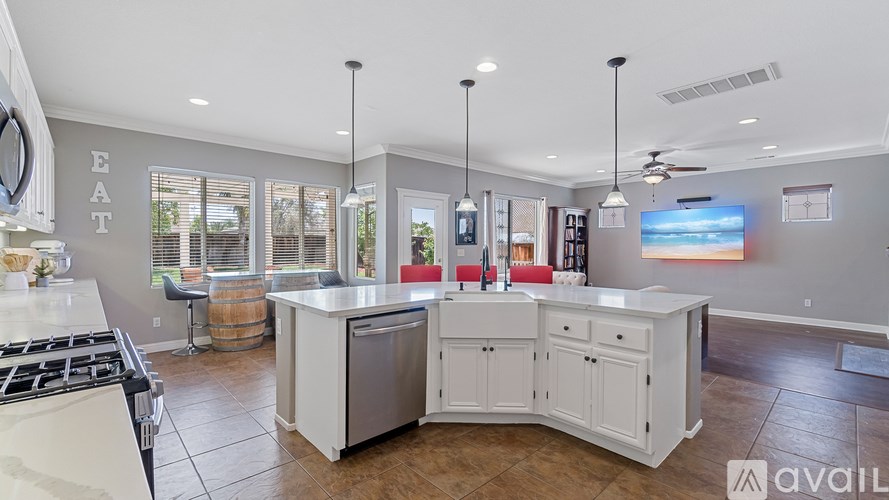 A kitchen with a white island and a stove top oven.