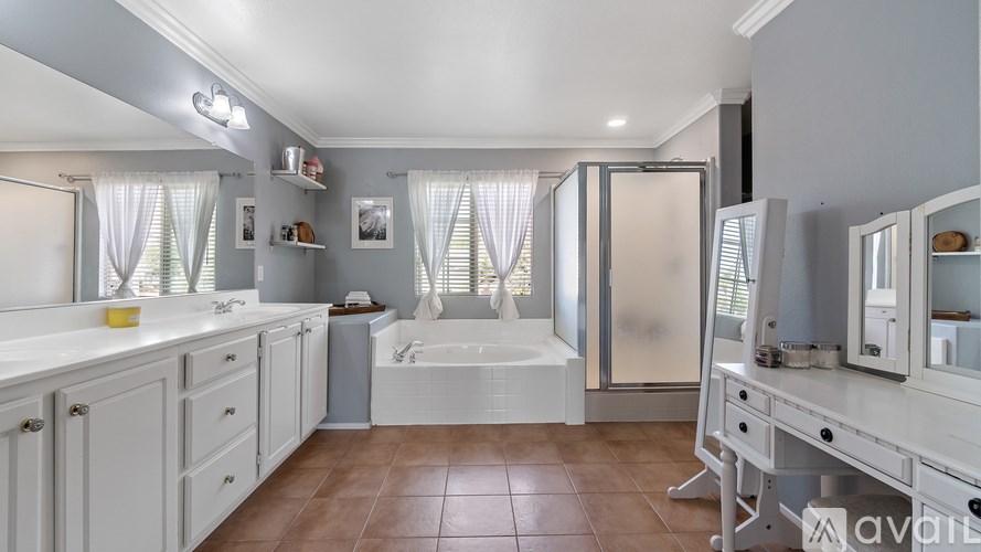 A bathroom with a white tub and sink.