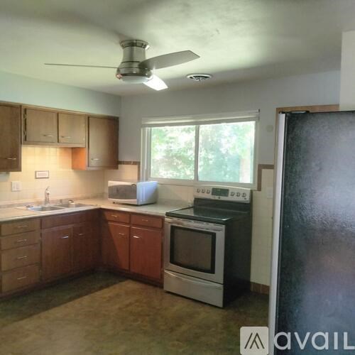 A kitchen with wooden cabinets and stainless steel appliances.