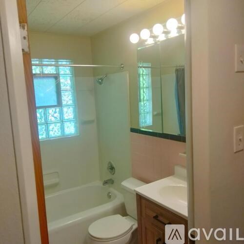A bathroom with a toilet, sink, and shower.