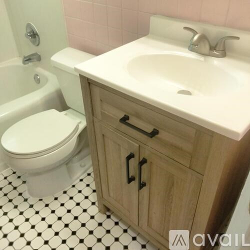 A white toilet sits next to a sink in a bathroom.