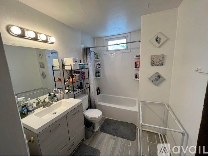 A bathroom with a toilet, sink, and shower.