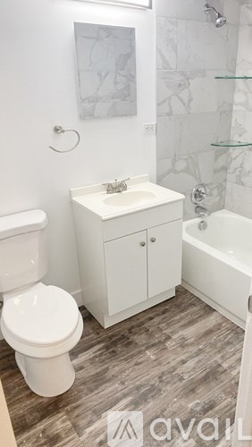 A white toilet sits next to a sink in a bathroom.