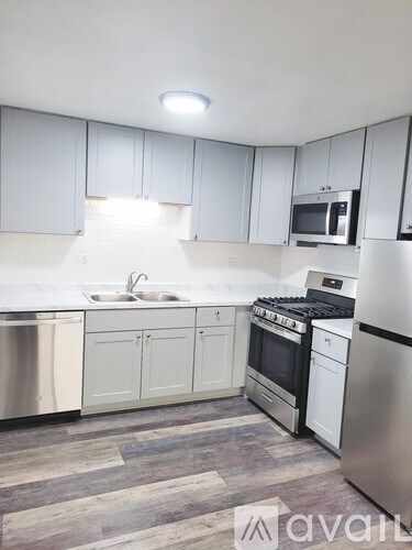 A kitchen with white cabinets and stainless steel appliances.