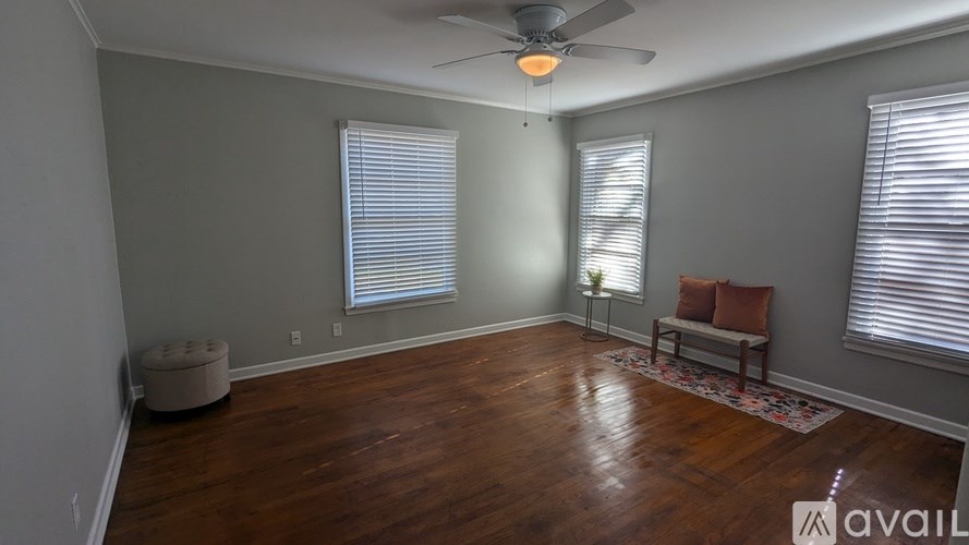 A room with wooden floors and a ceiling fan.