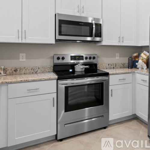 A kitchen with a stove top oven and microwave above it.