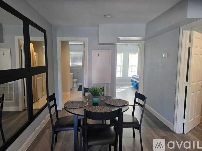A dining room with a table and chairs.