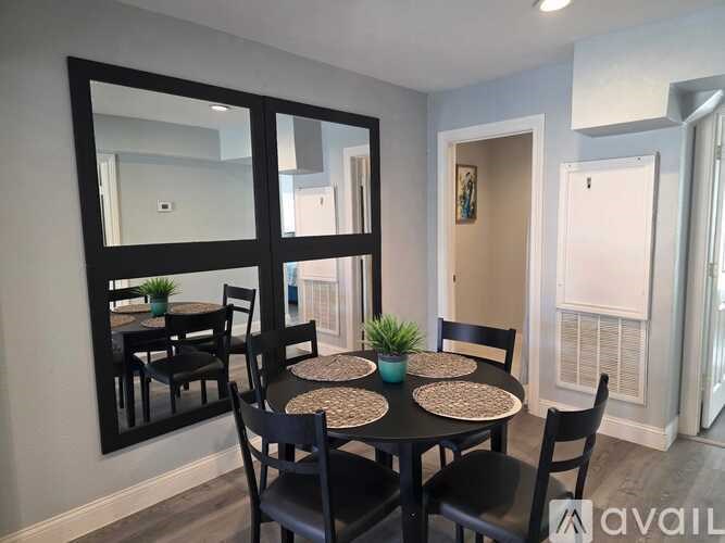 A dining room with a round table and chairs.