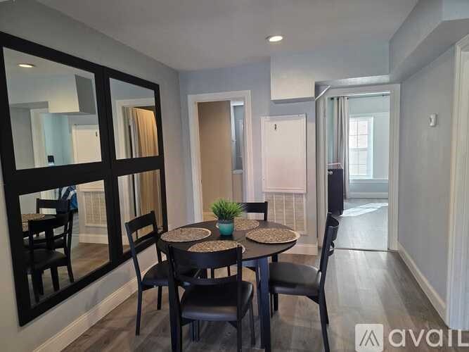 A dining room with a round table and chairs.