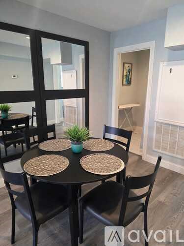 A dining room with a round table and chairs.