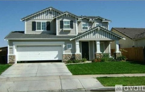A two-story house with a garage is available for sale.