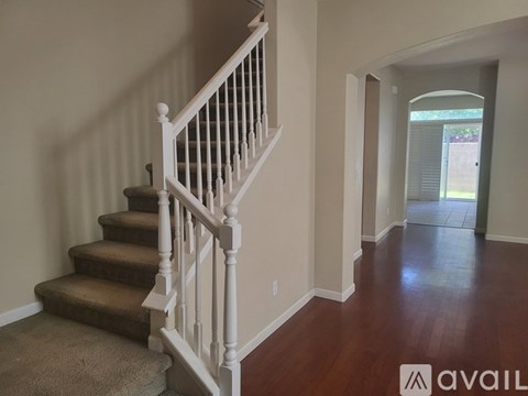 A hallway with a staircase leading to the second floor.