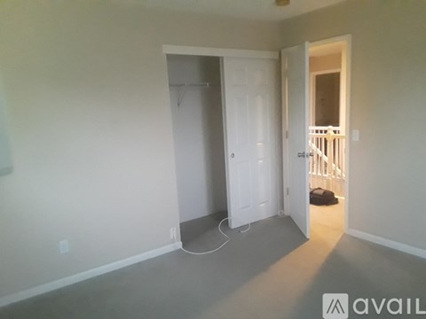 A room with a white door and a white wall.