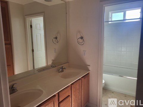 A bathroom with a white sink and a white tub.