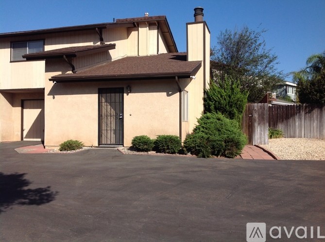 A house with a black gate and a brown roof.