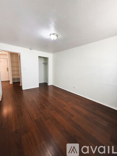 A room with wooden floors and white walls.